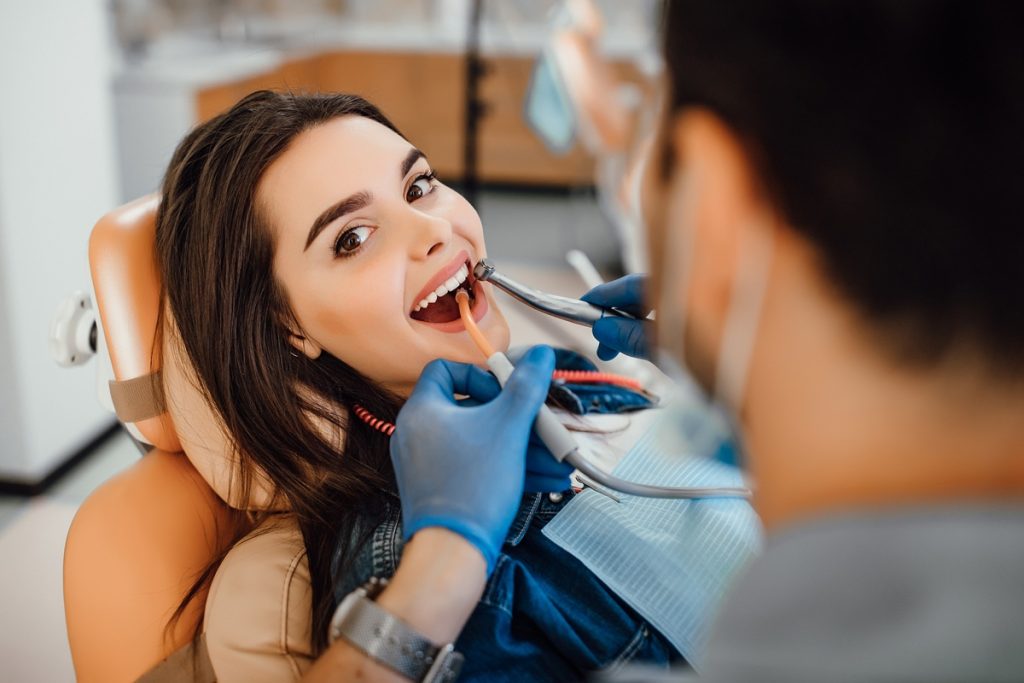 Dentist performing dental exam on patient at Dental Arts Toronto clinic