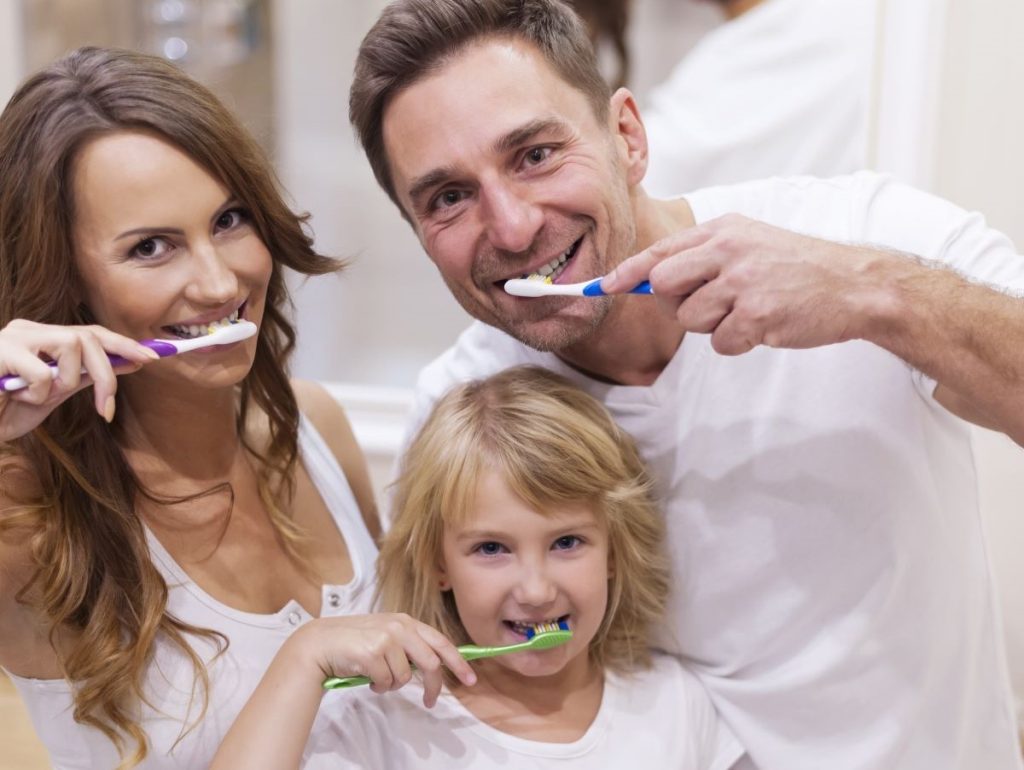 Family brushing together promoting preventive dental care in Toronto.