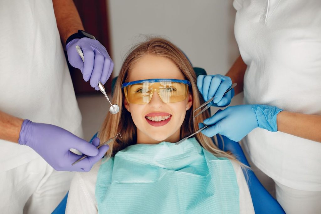 Young girl smiling during professional teeth cleaning at a Toronto dental clinic.