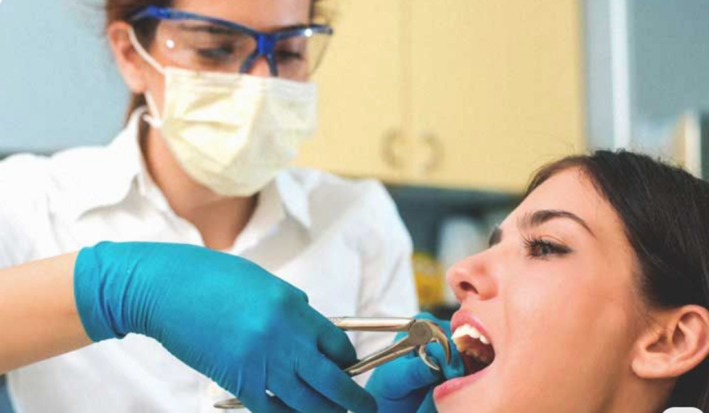 Young girl undergoing gentle tooth extraction in Toronto using sterilized surgical tools at Dental Arts.